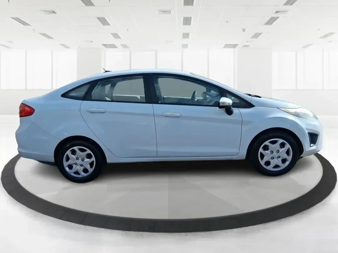 2013 Ford Fiesta SE (3FADP4BJXDM) with an 1.6L I-4 DOHC engine, located at 1951 S Dayton Lakeview Rd., New Carlisle, OH, 45344, (937) 908-9800, 39.890999, -84.050255 - Need a smart, efficient commuter that's easy to park downtown, nimble on I70, and still comfortable for weekend errands or a quick getaway to Springfield or Dayton? This 2013 Ford Fiesta SE Sedan in Oxford White delivers practical daily driving with the kind of budget-friendly ownership that fits re - Photo#1