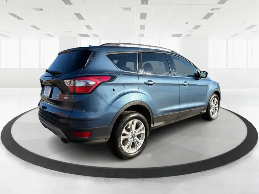 2018 Ford Escape SE (1FMCU9GD4JU) with an 1.5L L4 DOHC 16V engine, 6A transmission, located at 1230 East Main St, Xenia, OH, 45385, (937) 908-9800, 39.688026, -83.910172 - Picture your next Ohio weekend: loading up the kids for a splash at Splash Xenia, cruising out to John Bryan State Park for a hike, or tackling a snowy morning commute from Beavercreek to downtown Dayton with confidence. This 2018 Ford Escape SE in Blue Metallic is the kind of compact SUV that fits - Photo#2