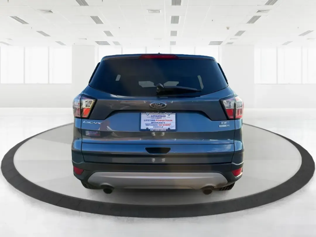 2018 Ford Escape SE (1FMCU9GD4JU) with an 1.5L L4 DOHC 16V engine, 6A transmission, located at 1230 East Main St, Xenia, OH, 45385, (937) 908-9800, 39.688026, -83.910172 - Picture your next Ohio weekend: loading up the kids for a splash at Splash Xenia, cruising out to John Bryan State Park for a hike, or tackling a snowy morning commute from Beavercreek to downtown Dayton with confidence. This 2018 Ford Escape SE in Blue Metallic is the kind of compact SUV that fits - Photo#3