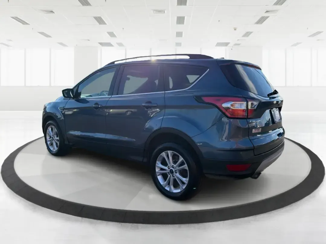 2018 Ford Escape SE (1FMCU9GD4JU) with an 1.5L L4 DOHC 16V engine, 6A transmission, located at 1230 East Main St, Xenia, OH, 45385, (937) 908-9800, 39.688026, -83.910172 - Picture your next Ohio weekend: loading up the kids for a splash at Splash Xenia, cruising out to John Bryan State Park for a hike, or tackling a snowy morning commute from Beavercreek to downtown Dayton with confidence. This 2018 Ford Escape SE in Blue Metallic is the kind of compact SUV that fits - Photo#4