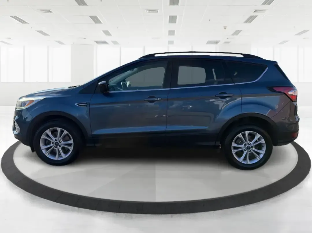 2018 Ford Escape SE (1FMCU9GD4JU) with an 1.5L L4 DOHC 16V engine, 6A transmission, located at 1230 East Main St, Xenia, OH, 45385, (937) 908-9800, 39.688026, -83.910172 - Picture your next Ohio weekend: loading up the kids for a splash at Splash Xenia, cruising out to John Bryan State Park for a hike, or tackling a snowy morning commute from Beavercreek to downtown Dayton with confidence. This 2018 Ford Escape SE in Blue Metallic is the kind of compact SUV that fits - Photo#5