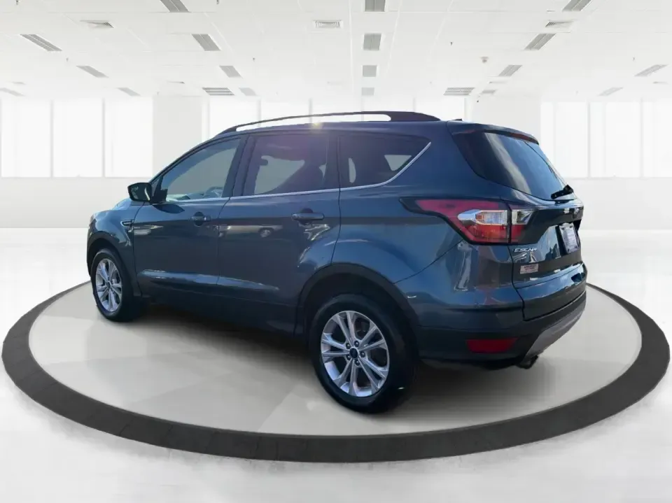2018 Ford Escape SE (1FMCU9GD4JU) with an 1.5L L4 DOHC 16V engine, 6A transmission, located at 880 E. National Road, Vandalia, OH, 45377, (937) 908-9800, 39.891918, -84.183594 - Picture your next Ohio weekend: loading up the kids for a splash at Splash Xenia, cruising out to John Bryan State Park for a hike, or tackling a snowy morning commute from Beavercreek to downtown Dayton with confidence. This 2018 Ford Escape SE in Blue Metallic is the kind of compact SUV that fits - Photo#4