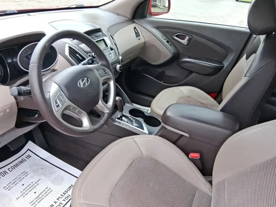 2013 Hyundai Tucson GLS (KM8JUCAC7DU) with an Theta II 2.4L I-4 DOHC engine, 6-Speed Automatic transmission, located at 8750 N County Rd 25A, Piqua, OH, 45356, (937) 908-9800, 40.164391, -84.232513 - Need a dependable SUV that can handle Ohio weather, school drop-offs, and weekend getaways without stretching your budget? This 2013 Hyundai Tucson GLS in eye-catching Garnet Red is built for real life-comfortable for daily commuting, confident on slick winter roads, and practical for everything fro - Photo#9