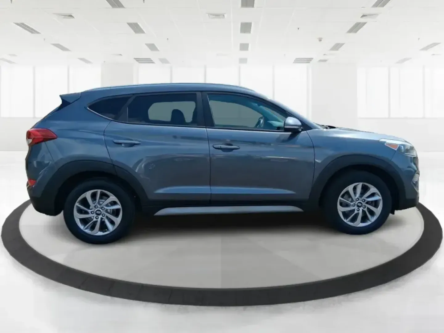 2018 Hyundai Tucson SEL Plus (KM8J33A4XJU) with an Nu 2L I-4 gasoline direct injection engine, 6A transmission, located at 8750 N County Rd 25A, Piqua, OH, 45356, (937) 908-9800, 40.164391, -84.232513 - Need a do-it-all SUV that fits real life in Greene County-school runs, long commutes to Dayton, and weekend getaways to John Bryan State Park-without sacrificing comfort or confidence? This 2018 Hyundai Tucson SEL Plus in Coliseum Gray is built for drivers who want practical space, modern tech, and - Photo#1