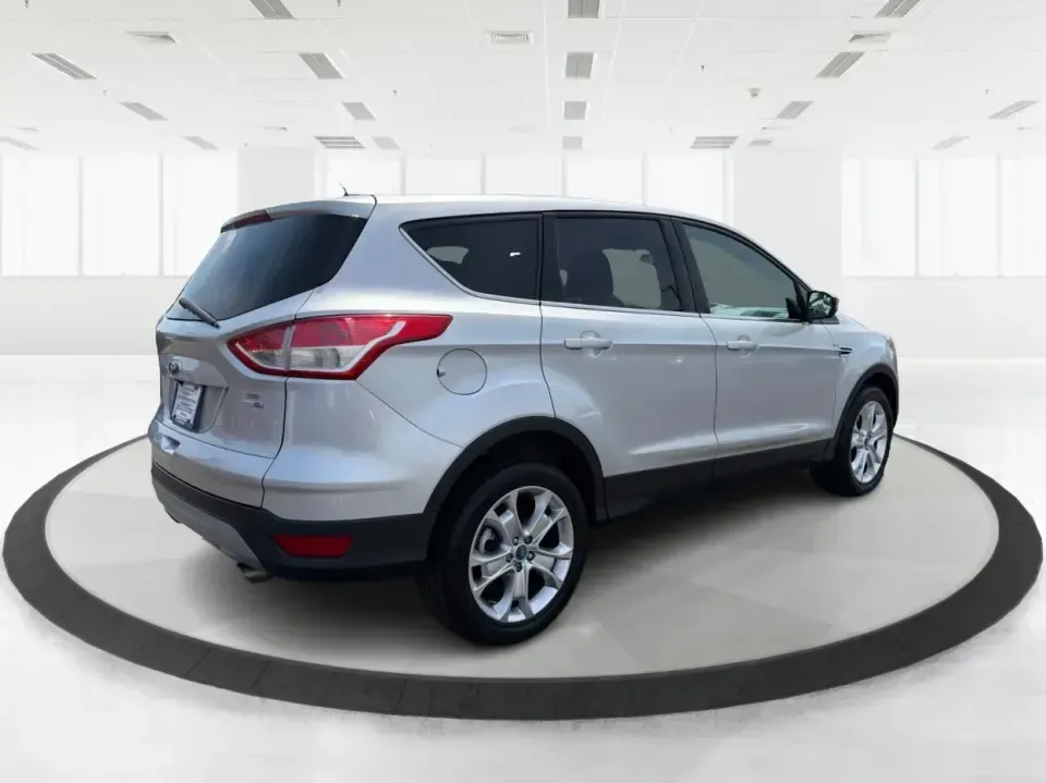 2015 Ford Escape SE (1FMCU9G98FU) with an 2.0L L4 DOHC 16V engine, 6-Speed Automatic transmission, located at 1099 N County Rd 25A , Troy, OH, 45373, (937) 908-9800, 40.057079, -84.212883 - Weekday commutes down I75, school drop-offs around Troy City Schools, and spontaneous weekend trips to Charleston Falls Preserve all get easier when you have an SUV that's the right size, the right power, and the right fit for your budget. This 2015 Ford Escape SE in Ingot Silver is built for real-l - Photo#2