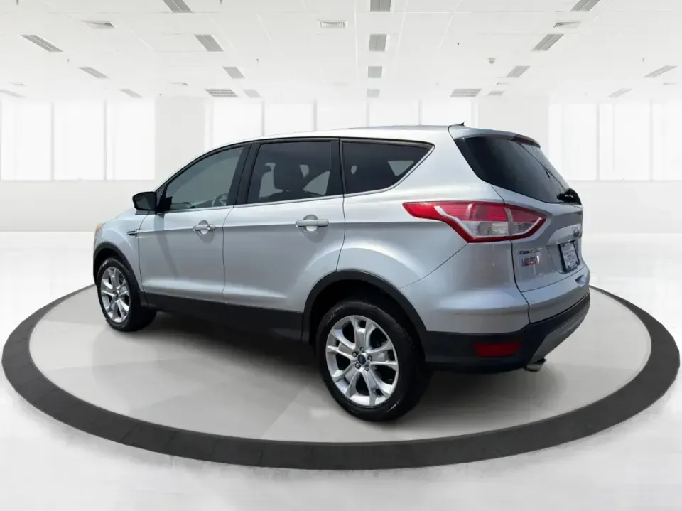 2015 Ford Escape SE (1FMCU9G98FU) with an 2.0L L4 DOHC 16V engine, 6-Speed Automatic transmission, located at 1099 N County Rd 25A , Troy, OH, 45373, (937) 908-9800, 40.057079, -84.212883 - Weekday commutes down I75, school drop-offs around Troy City Schools, and spontaneous weekend trips to Charleston Falls Preserve all get easier when you have an SUV that's the right size, the right power, and the right fit for your budget. This 2015 Ford Escape SE in Ingot Silver is built for real-l - Photo#4